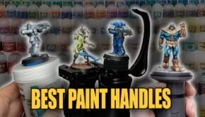 best painting handles shows various ones holding minatures with paint pots in backgournd