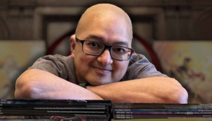 Lyle Lowery leaning on a stack of white dwarf magazines after 75 issue run
