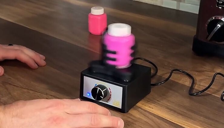 Vortex Mixer product shot in use with bottle on miniature paint on counter