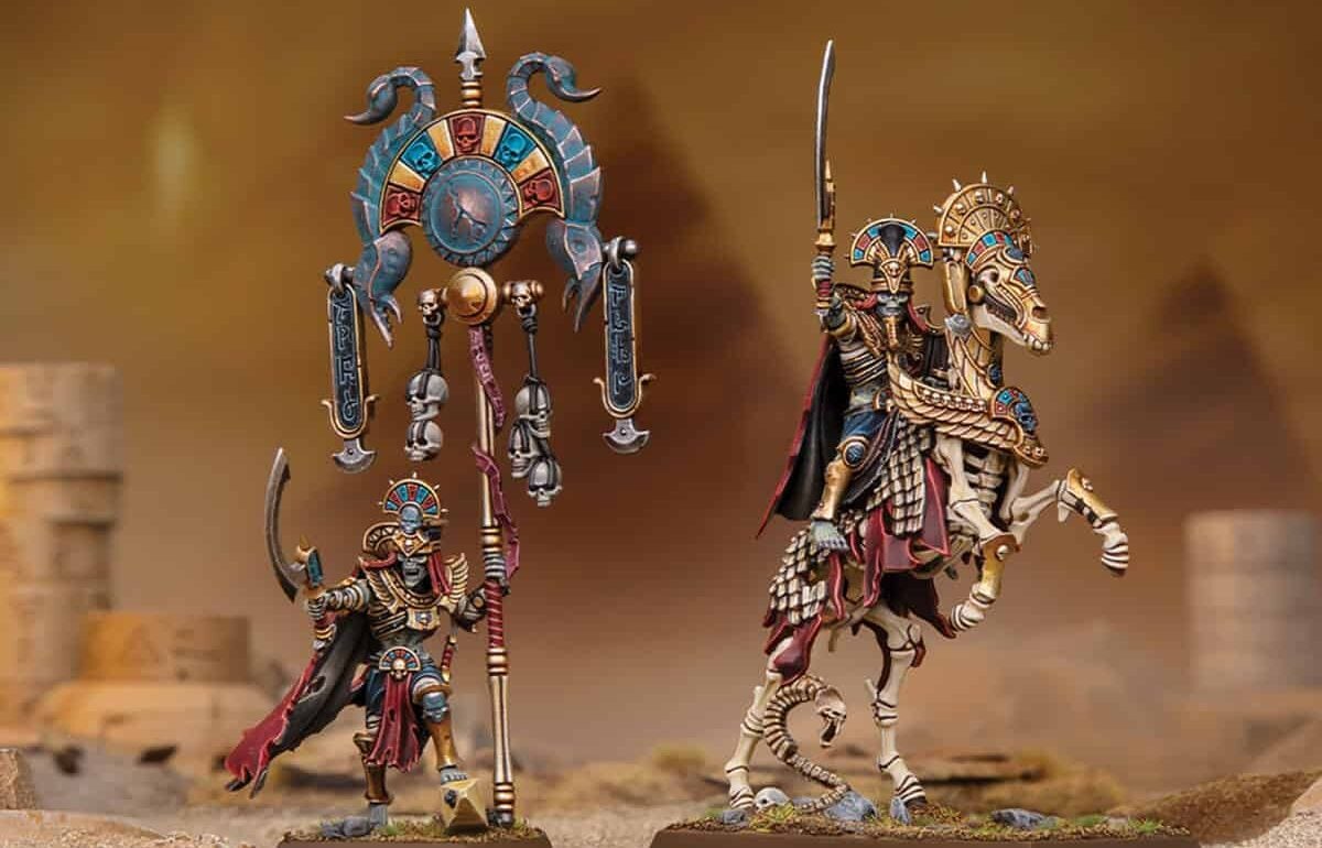 Warhammer Old World tomb kings new models revealed painted liche priests on sandy terrtain with shaded out pyramids