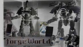 forge world large titan models assembled in a case inverse image so appear like ghosts with logo in front