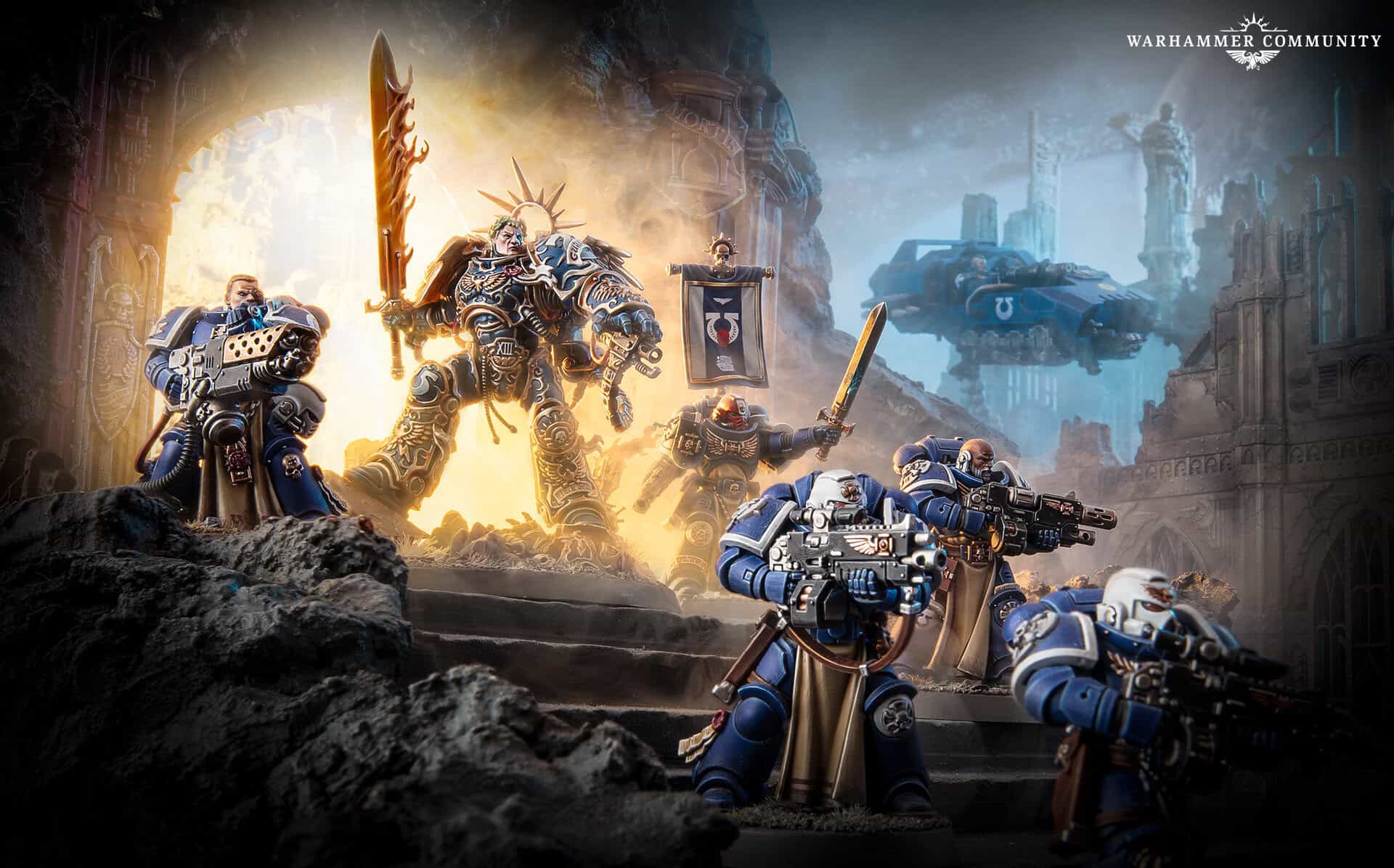 Roboute Guilliman in blue and gold armour striding across ruined battlefield terrain with Space Marines behind him
